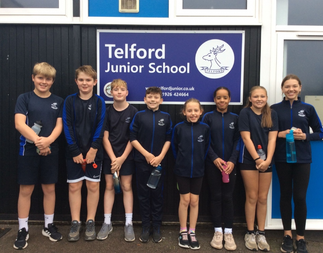 Indoor rowing team photographed in front of the school.